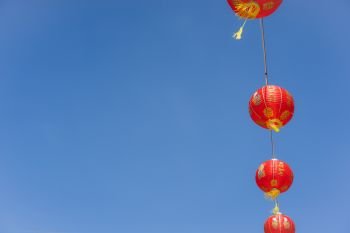 Chinese language mean rich or wealthy and happy.hot of arrangement decoration Chinese new year & lunar new year holiday background concept.China lantern hanging on beautiful blue sky on outdoor.