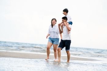 Happy family of father, mother and son goes vacation on a tropical sand beach in summer.. Happy family goes vacation on the beach in summer.