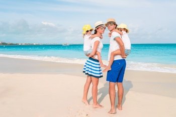 Young family on the beach. Photo of happy family having fun on the beach. Summer Lifestyle