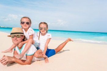 Father with kids on the beach. Family vacation. Happy beautiful family on a tropical beach vacation
