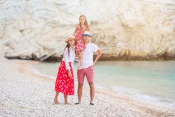 Portrait of family of three on the bech vacation. Beautiful tropical beach landscape with family enjoying summer vacation