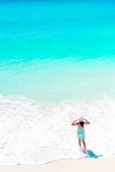 Beautiful woman on the beach in shallow water from above view. Happy girl at beach having a lot of fun in shallow water