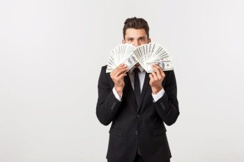 Portrait of a satisfied young businessman holding bunch of money banknotes isolated over white background. Portrait of a satisfied young businessman holding bunch of money banknotes isolated over white background.