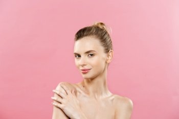 Beauty Concept - Beautiful Caucasian woman with clean skin, natural make-up isolated on bright pink background with copy space. Beauty Concept - Beautiful Caucasian woman with clean skin, natural make-up isolated on bright pink background with copy space.