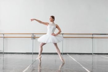 Beautiful ballerina rehearsal in ballet class, barre and white wall on background. Beautiful ballerina rehearsal in ballet class