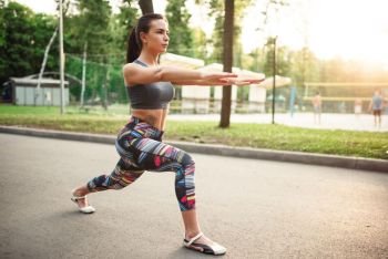 Athletic woman exercises, fitness training in park. Slim girl in sportswear, outdoor fit workout. Athletic woman exercises, fitness training in park