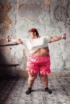 Fat woman on physical workout with dumbbells, fight against obesity, overweight problem. Fastfood eating. Fat woman on workout with dumbbells, obesity