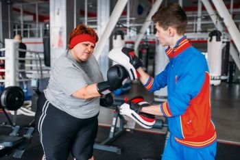 Athlete in sportswear, training on exercise machine in gym. Bearded man on workout in sport club, healthy lifestyle. Athlete in sportswear on exercise machine in gym