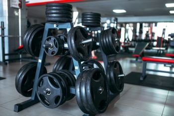 Weights for a bar, sport equipment in gym, fitness club interior, bodybuilding concept