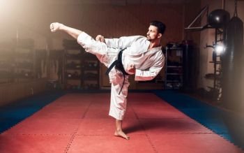 Martial arts, man in white kimono with black belt, karate training kata in gym. Martial arts, man in white kimono with black belt
