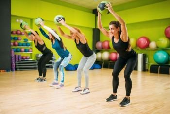 Women group with balls, fitness workout. Female sport teamwork in gym. Fit exercise, aerobic. Women group with balls, fitness workout