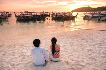 Couple relaxing beautiful sunset on Koh Lipe Beach Thailand ,Summer vacation