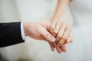 Wedding moments. Newly wed couple’s hands with wedding rings