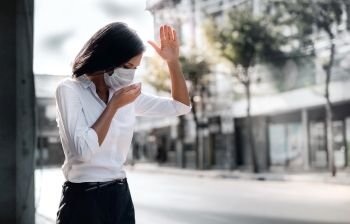 Covid-19 or Corona Virus or Air Pollution PM2.5 Situation Concept. Young Woman with Medical Mask Coughing in Public
