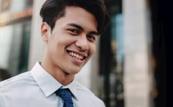 Headshot of Happy Urban Businessman in the City. Young Friendly Man. Looking at the Camera