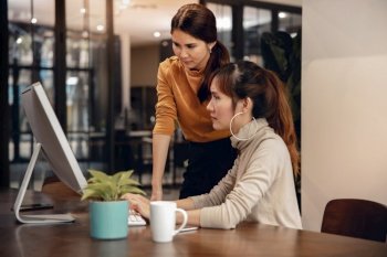 Working Together. Stressed Two Business Woman Workigng on Computer in Modern Office. Female Boss and Employee