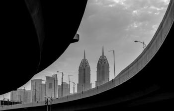 Black white detail pictures of a bridge in Dubai. Skyscraper in the background. Al Kazim Towers in the background.. Al Kazim Towers 