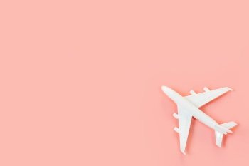 Top view of model plane, airplane on pink color background, travel concept. Flat lay , copy space