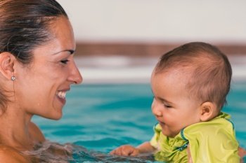 Mother with cute baby boy in the swimming pool