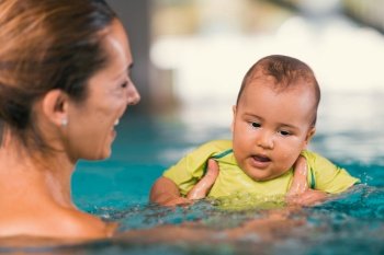 Mother with baby boy in the swimming pool