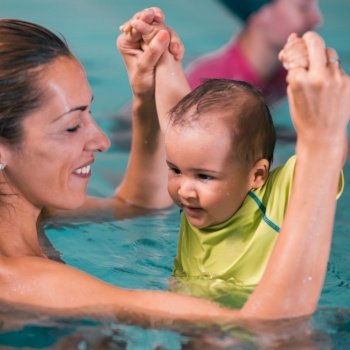 Mother with baby boy, swimming class, indoor swimming pool