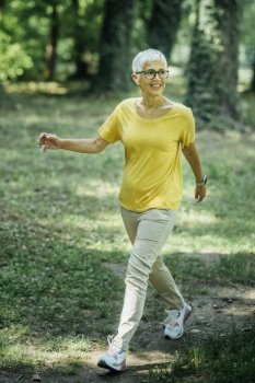 Senior Woman Enjoying Walking Exercise in Nature