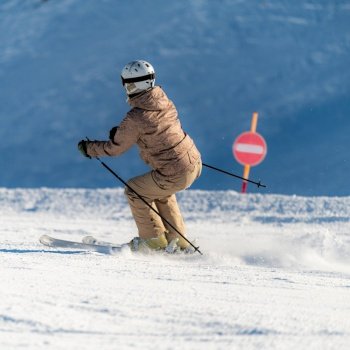Female skier skiing down the slope