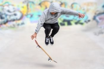 young skater doing jump trick at skate park .. young skater doing jump trick at skate park.