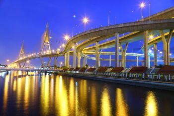  Bridge in Thailand, also known as the Industrial Ring Road Bridge, in Thailand. The bridge crosses the Chao Phraya River twice at twilight.