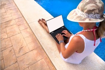 Girl lady looking at email and work with laptop by the swimming pool