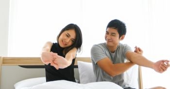 Asian couples lover waking up in her bed fully rested in morning