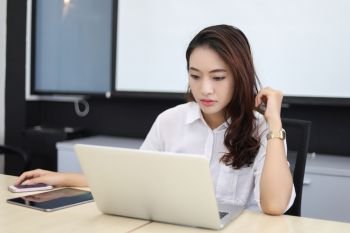 Asian business women using notebook and  serious and headache for working 