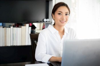 Asian business women using notebook and  smiling happy for working 