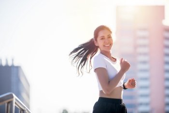 smiling Asian Young fitness sport woman running  and Sportive people training in a urban area, healthy lifestyle and sport concepts
