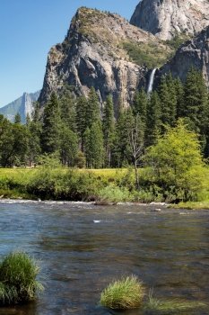 Waterfall and the Merced River  in Yosemite on a Summer’s Day