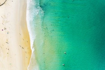 Aerial view of beautiful sandy beach with tourists swimming in beautiful andaman sea in phuket thailand,Amazing nature background and summer background.