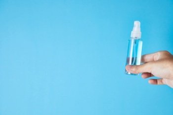 Closeup bottle of blue alcohol hand spray. corona virus concept
. Closeup bottle of blue alcohol hand spray.