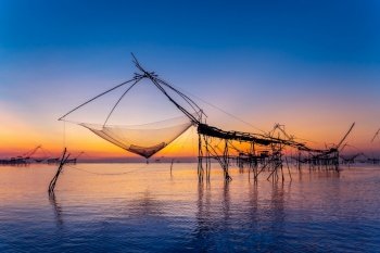 Beautiful sunrise and fishing dip nets at Pakpra in Phatthalung, Thailand.