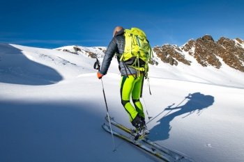 Climb with skis and seal skins in virgin snow.