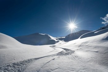Skier tracks in fresh snow alone on the italian alps
