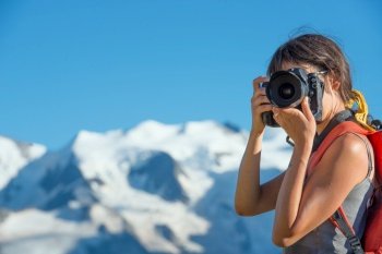 Girl photographing in high mountains