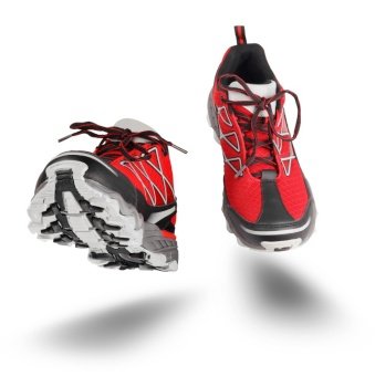 Red running sport shoes seen front, isolated on white background