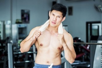 Attractive Handsome Asian men smile after work out in gym cool down and relax muscle in strong body,Bodybuilder Concept