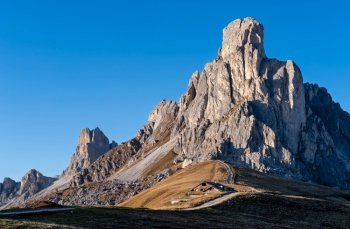 Italian Dolomites mountain (Ra Gusela rock in front) peaceful sunny evening view from Giau Pass. Picturesque climate, environment and travel concept scene.