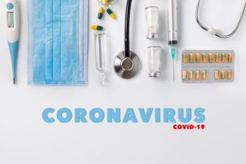 Protective masks, medicines, thermometer, stethoscope and syringe with coronavirus text on a white background. Novel coronavirus 2019-nCoV, MERS-Cov middle East respiratory syndrome coronavirus.