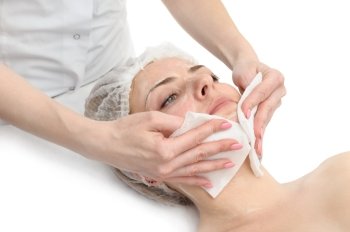 Beauty treatment procedure, wiping the facial mask from face