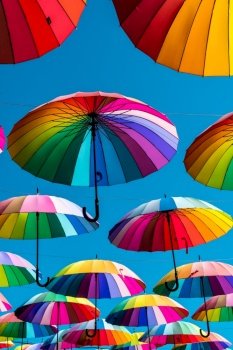 Rainbow umbrella above the street, LGBT symbols.