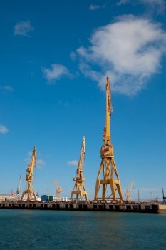 Cranes of the dockyards of Cadiz in a sunny day. Dockyards of Cadiz