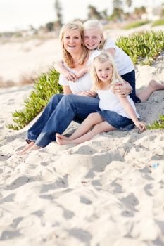 Pretty Mom and Her Cute Daughters Portrait at The Beach.