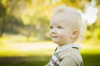 Adorable Little Blonde Baby Boy Outdoors at the Park.

